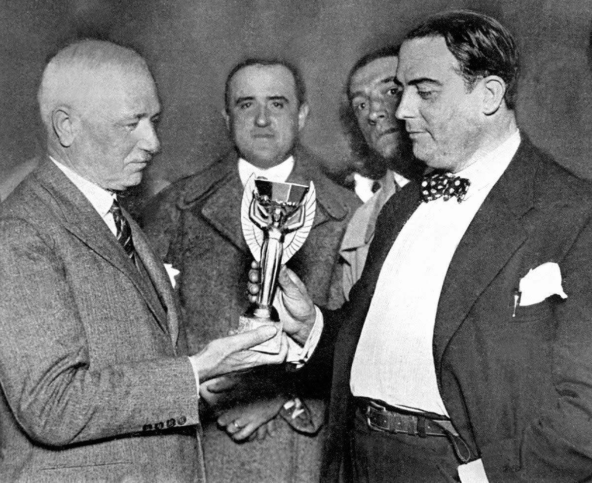 Fifa president Jules Rimet presents the first World Cup to Uruguay (AFP via Getty Images)