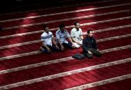 <p>Muslim men pray in a mosque on the third day of Ramadan in Jakarta, Indonesia, May 29, 2017. (AP Photo/Tatan Syuflana) </p>