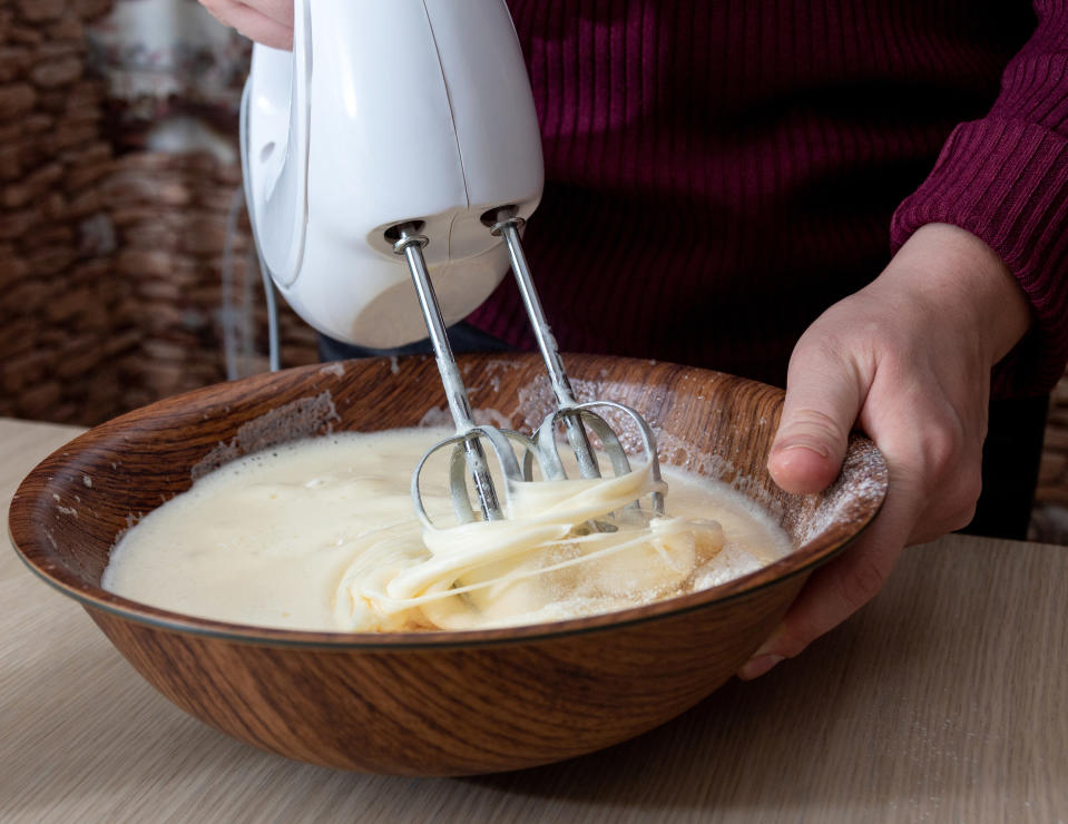 Mixing batter in a wooden mixing bowl