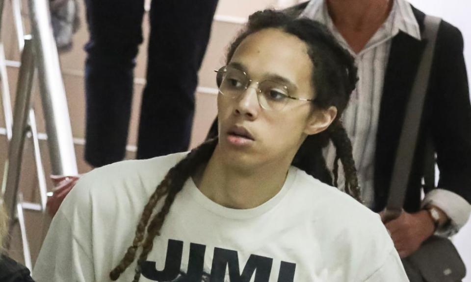 WNBA star Brittney Griner is escorted to a courtroom for a hearing, in Khimki city court outside Moscow on Friday.