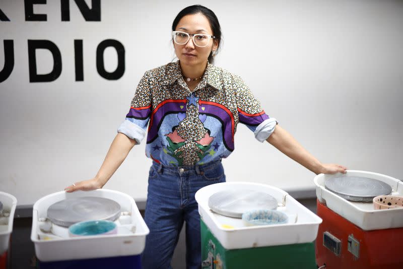 Jing Xeu poses inside her business Token Studio, amid the coronavirus disease (COVID-19) outbreak, in London