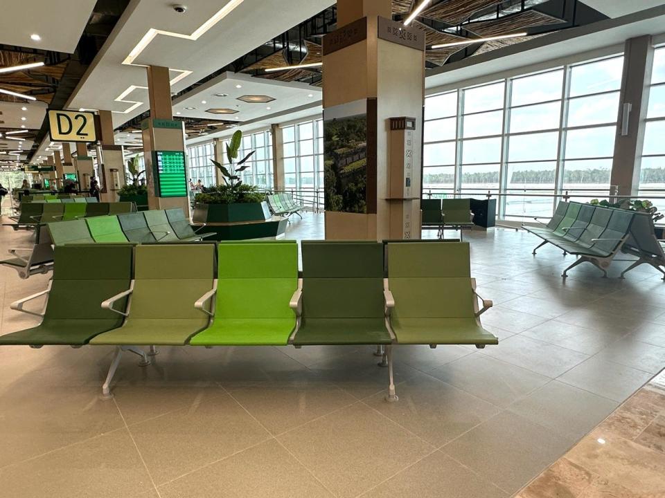 Green chairs at Tulum Airport