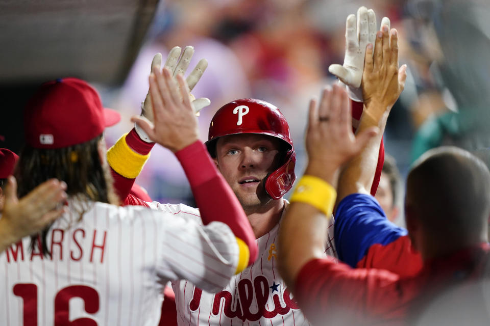 Philadelphia Phillies' Rhys Hoskins celebrates with teammates after hitting a home run against Washington Nationals pitcher Patrick Corbin during the fourth inning of a baseball game, Friday, Sept. 9, 2022, in Philadelphia. (AP Photo/Matt Slocum)