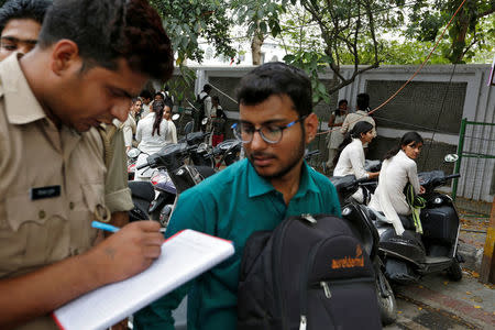 The "Anti-Romeo Squad" question a youth following regulations imposed by newly elected Uttar Pradesh State Chief Minister, Yogi Adityanath, in Lucknow, India, April 6, 2017. REUTERS/Cathal McNaughton