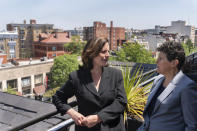 In this May 21, 2021, photo overlooking the Dupont Circle neighborhood, Washington based civil rights attorneys Lisa Banks, left, and Debra Katz chat after a portrait session at their law firm in Washington. For many people, the pandemic year has brought a pause of some kind, or at least a slowdown, to their professional endeavors. For Katz and Banks, the opposite has been true. “This is probably the biggest year we’ve ever had,” says Banks. Their work has been increasing for nearly four years. When the Harvey Weinstein revelations erupted in October 2017, launching the reckoning that became known as the #MeToo movement, it caused “a sea change," Katz says. (AP Photo/Jacquelyn Martin)