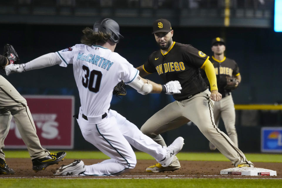 San Diego Padres first baseman Eric Hosmer gets the force out on Arizona Diamondbacks' Jake McCarthy (30) in the third inning during a baseball game, Tuesday, Aug. 31, 2021, in Phoenix. (AP Photo/Rick Scuteri)