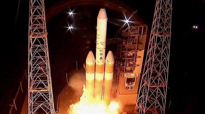 Fire erupts from the base of a Delta 4 Heavy rocket as gaseous hydrogen ignites during first stage engine ignition and shutdown in a 