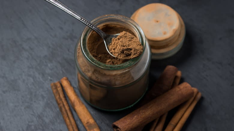 jar of ground cinnamon with spoon