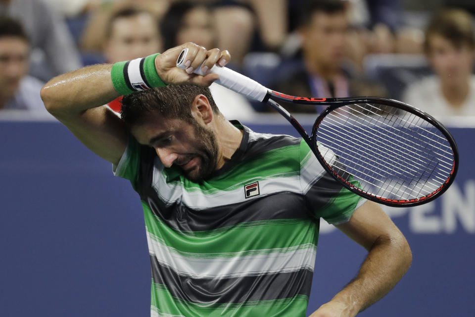 Marin Cilic, of Croatia, pauses during a third-round match against Alex de Minaur, of Australia, at the U.S. Open tennis tournament Saturday, Sept. 1, 2018, in New York. (AP Photo/Mark Lennihan)