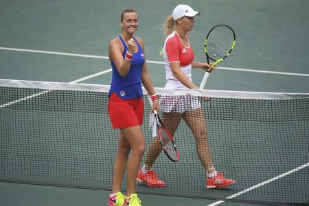 2016 Rio Olympics - Tennis - Preliminary - Women's Singles Second Round - Olympic Tennis Centre - Rio de Janeiro, Brazil - 08/08/2016. Petra Kvitova (CZE) of Czech Republic celebrates next to Caroline Wozniacki (DEN) of Denmark after winning their match. REUTERS/Toby Melville