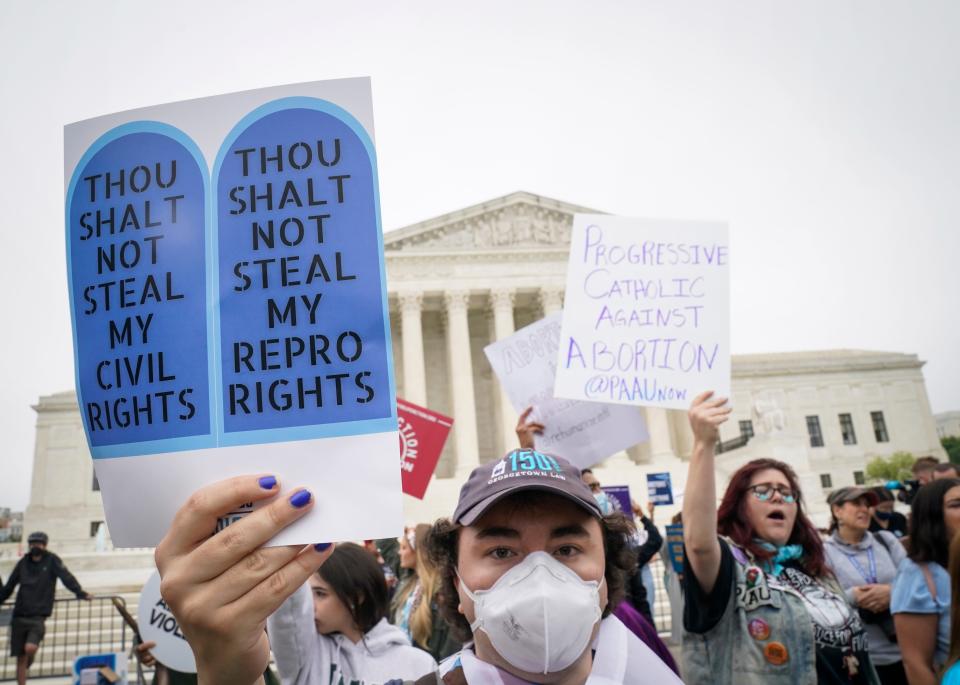 Demonstrators on both sides of the abortion debate gather outside the Supreme Court in Washington.