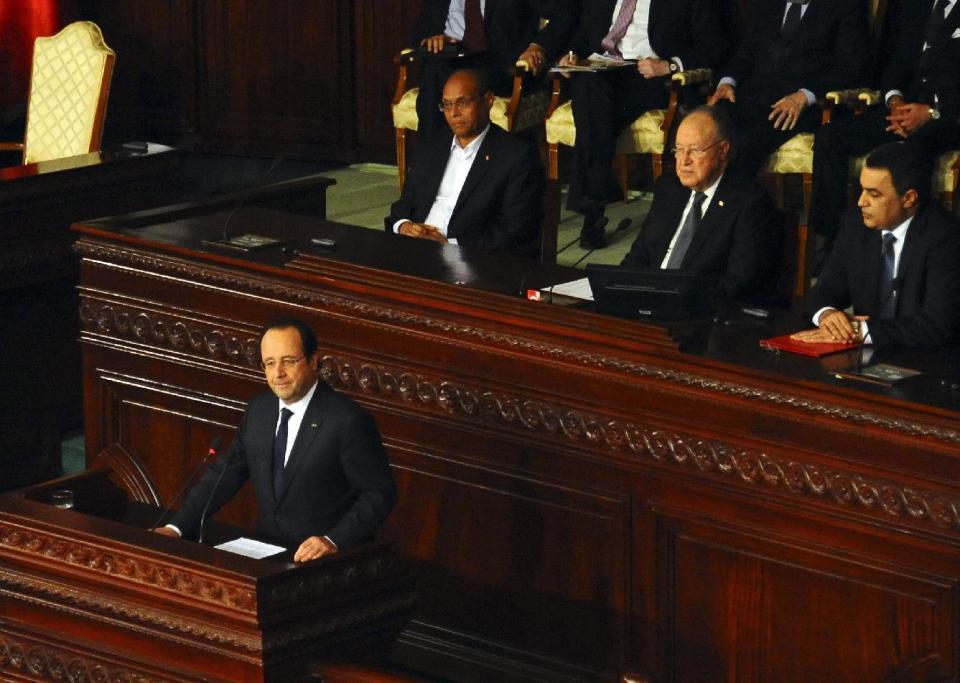 French President Francois Hollande delivers his speech as from background left, Tunisian President Moncef Marzouki, Assembly, speaker Mustapha Ben Jaafar, and Tunisian Prime Minister Mehdi Jomaa, right, listen, during a ceremony at the Constituent Assembly in Tunis, Friday, Feb. 7, 2014. Hollande and other world leaders attended a ceremony for the formal adoption of a document being praised as one of the most progressive constitutions in an Arab nation. (AP Photo/Hassene Dridi)