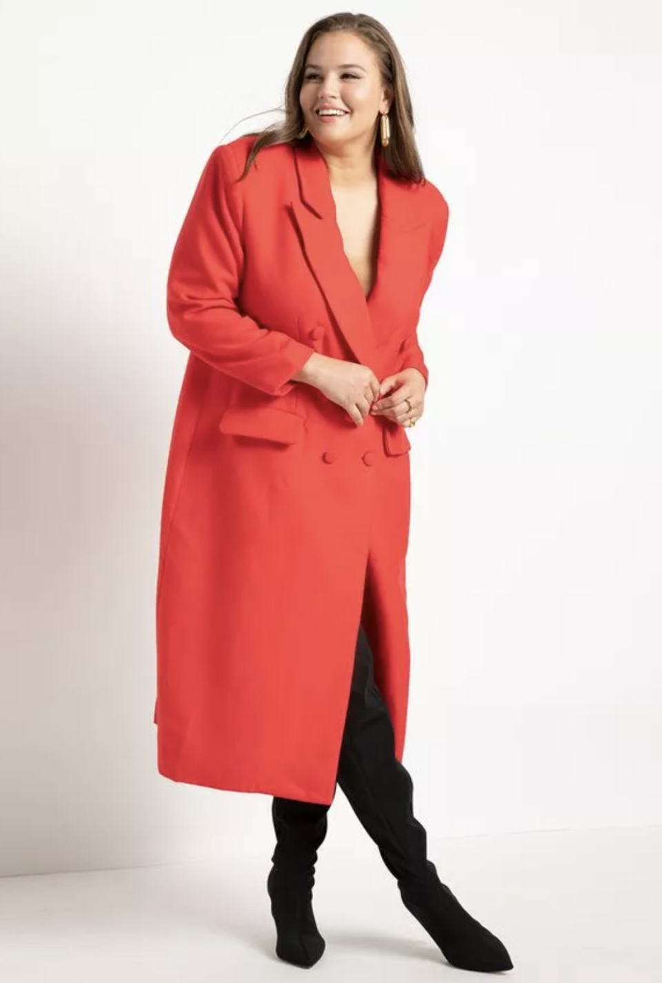 plus size model in black boots and red Strong Shoulder Coat With Cinched Waist (Photo via Eloquii)