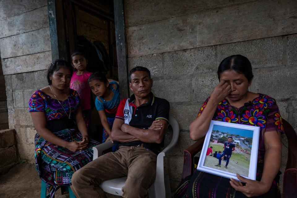 Catarina Tambriz Tambriz holds a photo of her dead son Diego Tzaj Ixtos as her husband, Francisco Tzaj Quemá, and their three daughters look on. Tzaj Ixtos died in a March 27, 2023, fire in a migrant detention center fire in Juárez, Mexico.