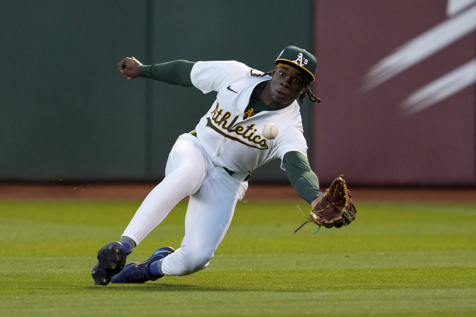 Oakland Athletics right fielder Lawrence Butler dives to catch a fly ball hit by St. Louis Cardinals' Jordan Walker during the fourth inning of a baseball game Monday, April 15, 2024, in Oakland, Calif. (AP Photo/Godofredo A. Vásquez)