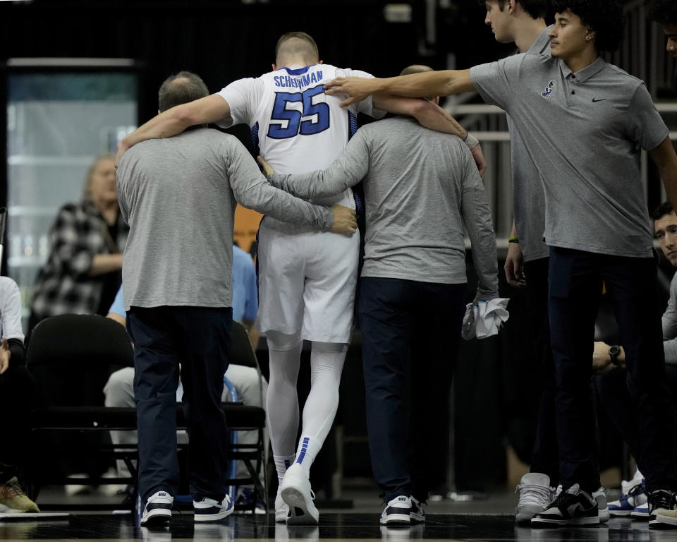 Creighton guard Baylor Scheierman (55) is helped off he court after an injury during the second half of an NCAA college basketball game against Colorado State Thursday, Nov. 23, 2023, in Kansas City, Mo. Colorado State won 69-48. (AP Photo/Charlie Riedel)