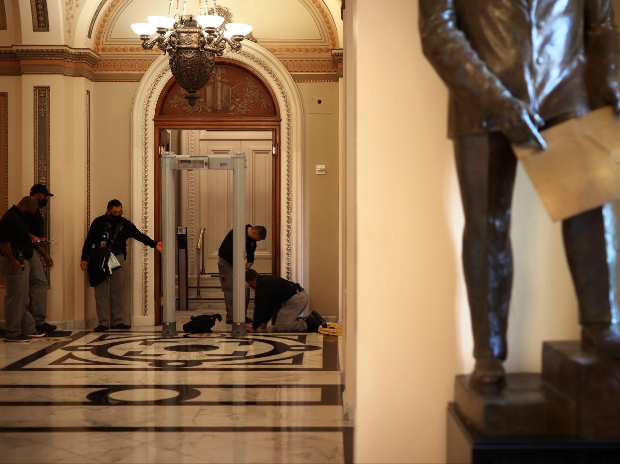 <p>US Capitol Police install a metal detector at the doors of the House of Representatives Chamber on 12 January 2021 in Washington, DC.</p> ((Getty Images))