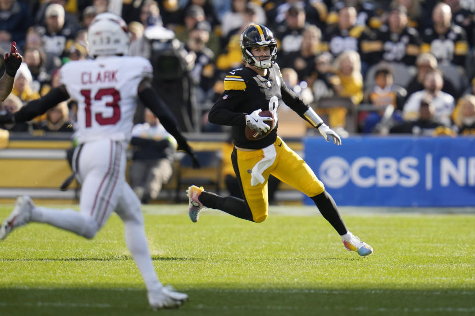 Pittsburgh Steelers quarterback Kenny Pickett, right, runs with the ball against Arizona Cardinals cornerback Kei'Trel Clark (13) during the first half of an NFL football game Sunday, Dec. 3, 2023, in Pittsburgh. (AP Photo/Gene J. Puskar)