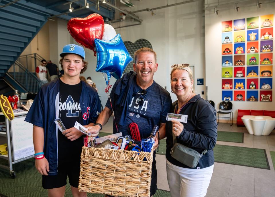 Liam Akins, Ken Akins and Noreen Akins (left to right) were the guests of honor at the WooSox game on Friday.