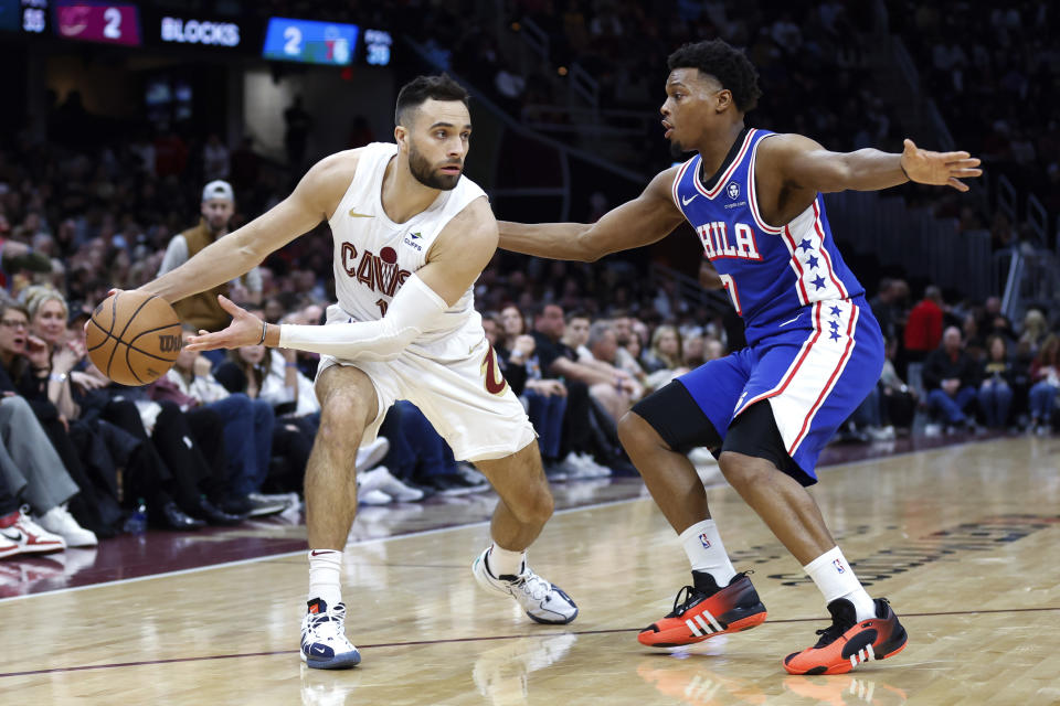Cleveland Cavaliers guard Max Strus (1) looks to pass the ball as Philadelphia 76ers guard Kyle Lowry (7) defends during the second half of an NBA basketball game Friday, March 29, 2024, in Cleveland. (AP Photo/Ron Schwane)