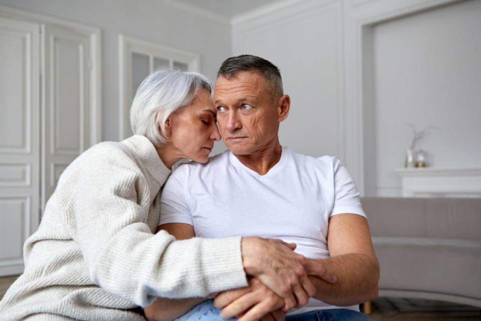 Sad frustrated old couple going through conflict, row, quarrel, ignoring each other, sitting on couch at home. Upset senior elder husband and wife