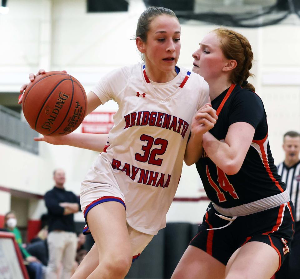 Bridgewater-Raynham's Camden Strandberg dribbles past Newton North defender Maggie Scanlon during a game on Friday, Dec. 22, 2023. Bridgewater-Raynham won the game 41-33.