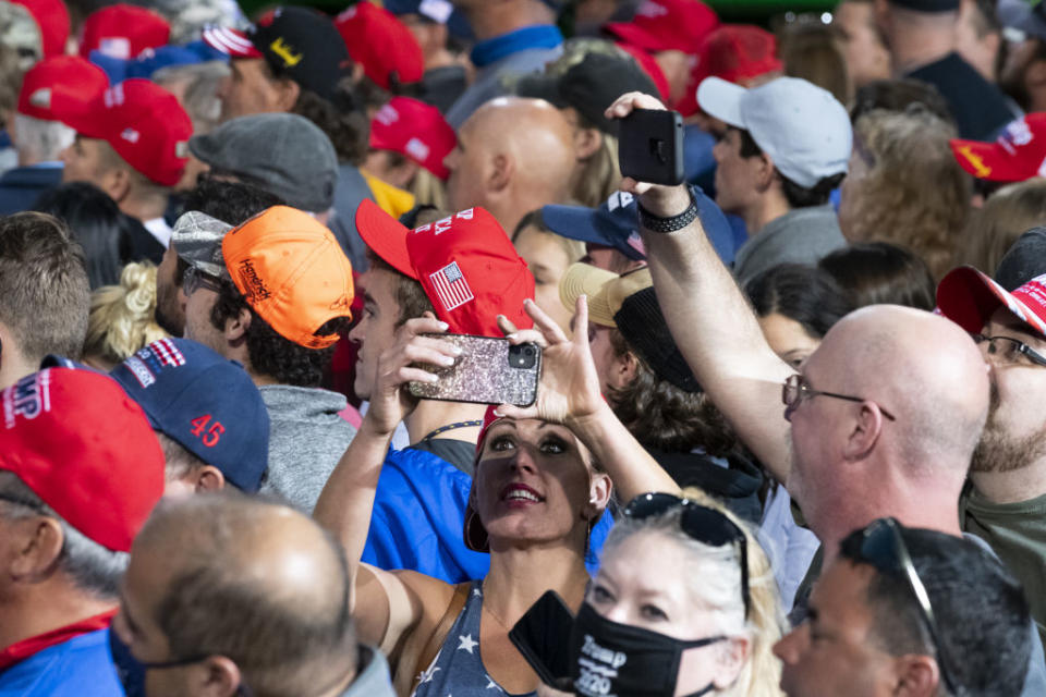 Attendees wait for Trump at a campaign rally.