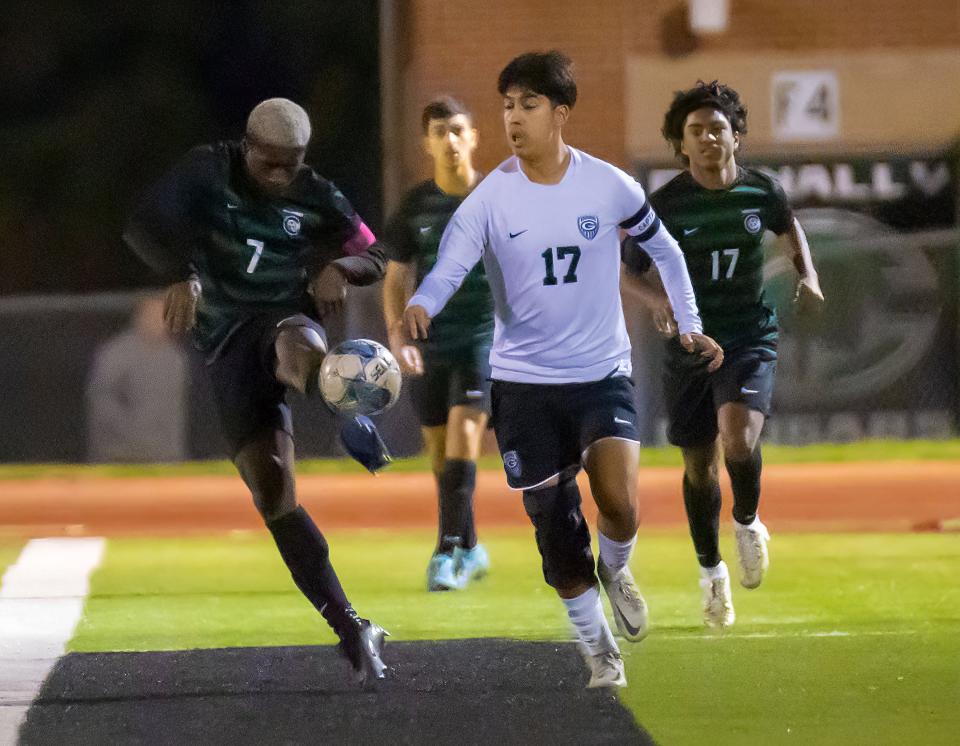 Connally Cougars Lawrence Doe (7) kicks the ball away from Connally Cougars Joshua Montero (17) during the first half at the District 23-5A boys soccer game on Feb 16, 2024, at Connally High School in Pflugerville, TX.