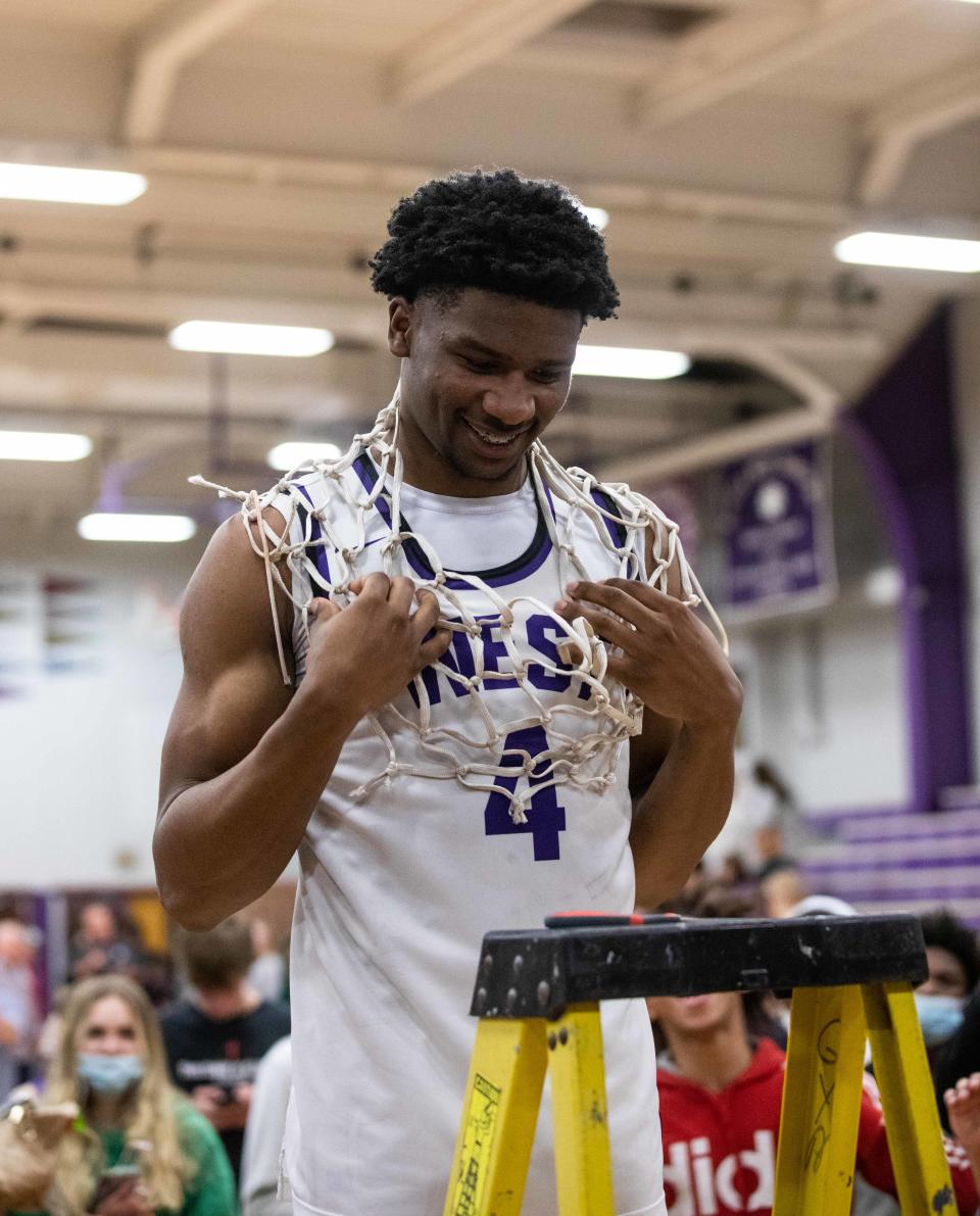 Topeka West senior Elijah Brooks cuts down the net March 4 after claiming the 2022 Class 6A Sub-State Championship over Andover. Brooks played in the KBCA All-Star game Saturday.