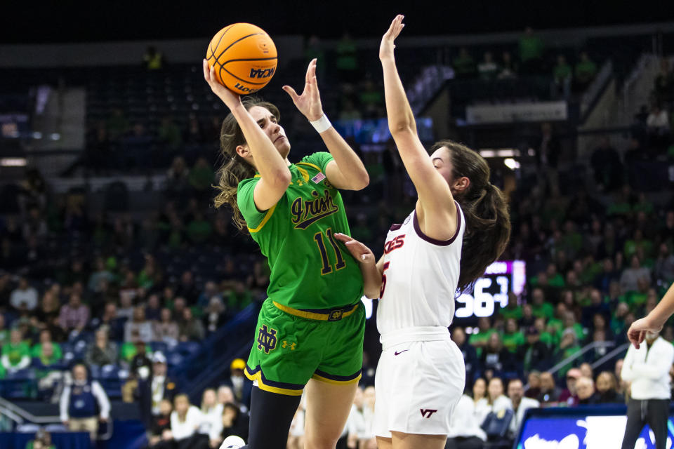 Notre Dame guard Sonia Citron (11) shoots as Virginia Tech guard Georgia Amoore, right, defends during the second half of an NCAA college basketball game Thursday, Feb. 29, 2024, in South Bend, Ind. (AP Photo/Michael Caterina)