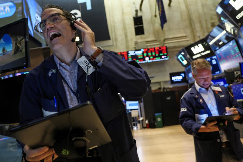 FILE PHOTO: Traders work on the floor of the NYSE in New York