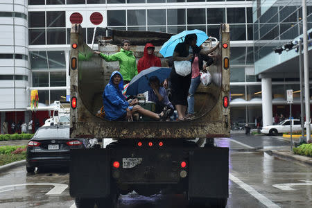 Evacuees are transported to the George R. Brown Convention Center after Hurricane Harvey inundated the Texas Gulf coast with rain causing widespread flooding, in Houston, Texas, U.S. August 27, 2017. REUTERS/Nick Oxford