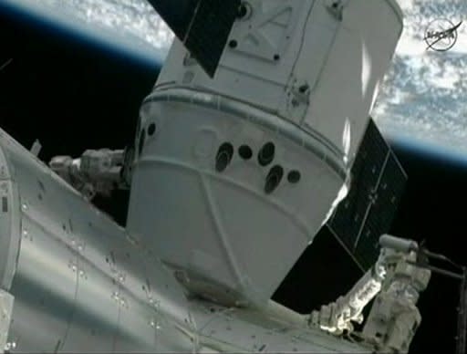 In this frame grab from a NASA video, the SpaceX Dragon capsule is seen docked to the International Space Station May 25. SpaceX became the first commercial outfit to send its own cargo capsule to the International Space Station, heralding the start of a new era for private spaceflight