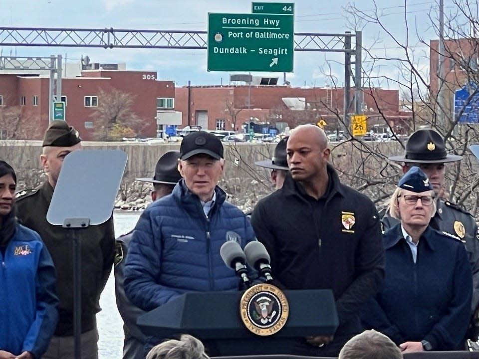 President Joe Biden speaks from the lectern near the collapsed Francis Scott Key Bridge while Maryland Gov. Wes Moore listens outside the Maryland Transportation Authority Police headquarters in Dundalk on April 5, 2024.