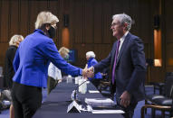 Sen. Elizabeth Warren, D-Mass., greets Federal Reserve Chairman Jerome Powell before a Senate Banking, Housing and Urban Affairs Committee hearing on the CARES Act on Capitol Hill, Tuesday, Sept. 28, 2021 in Washington. (Kevin Dietsch/Pool via AP)