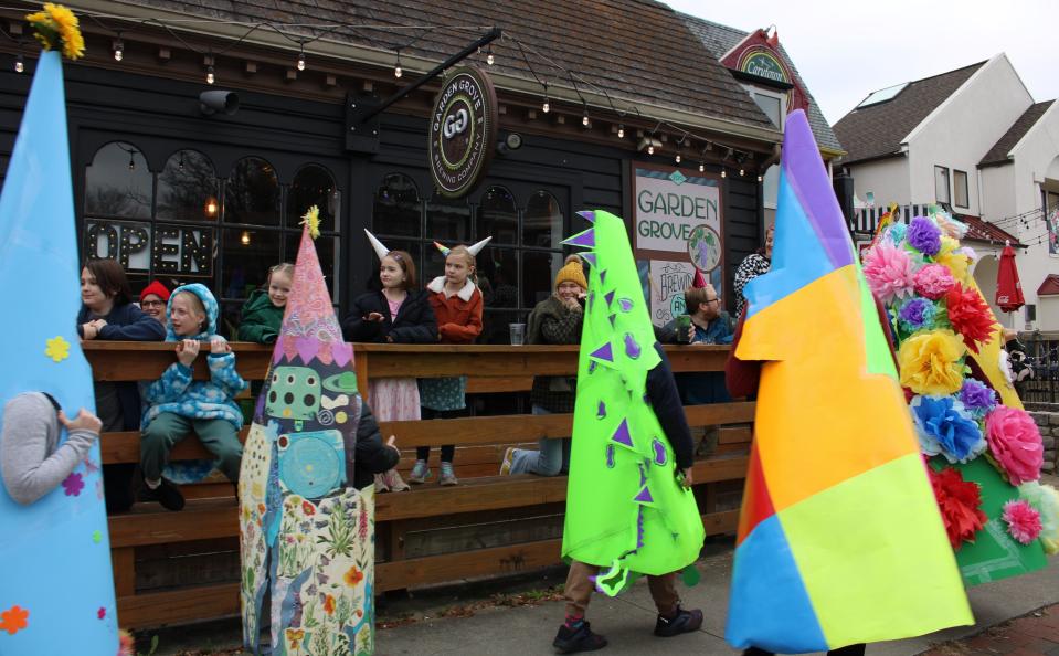 Spectators at Garden Grove Brewing Company watch 16th Annual Carytown Cone Parade on January 1, 2024.