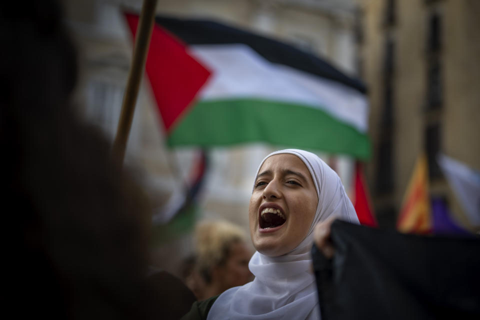 Demonstrators hold Palestinian flags during a protest against Israeli airstrikes on Gaza and to show solidarity with the Palestinian people, in Barcelona, Spain, Sunday, Oct. 8, 2023. (AP Photo/Emilio Morenatti, File)