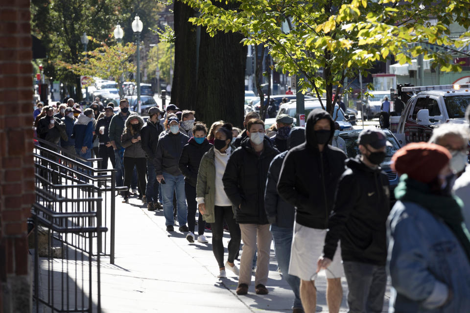 People wait in line to vote at Fenway Park, Saturday, Oct. 17, 2020, in Boston. (AP Photo/Michael Dwyer)