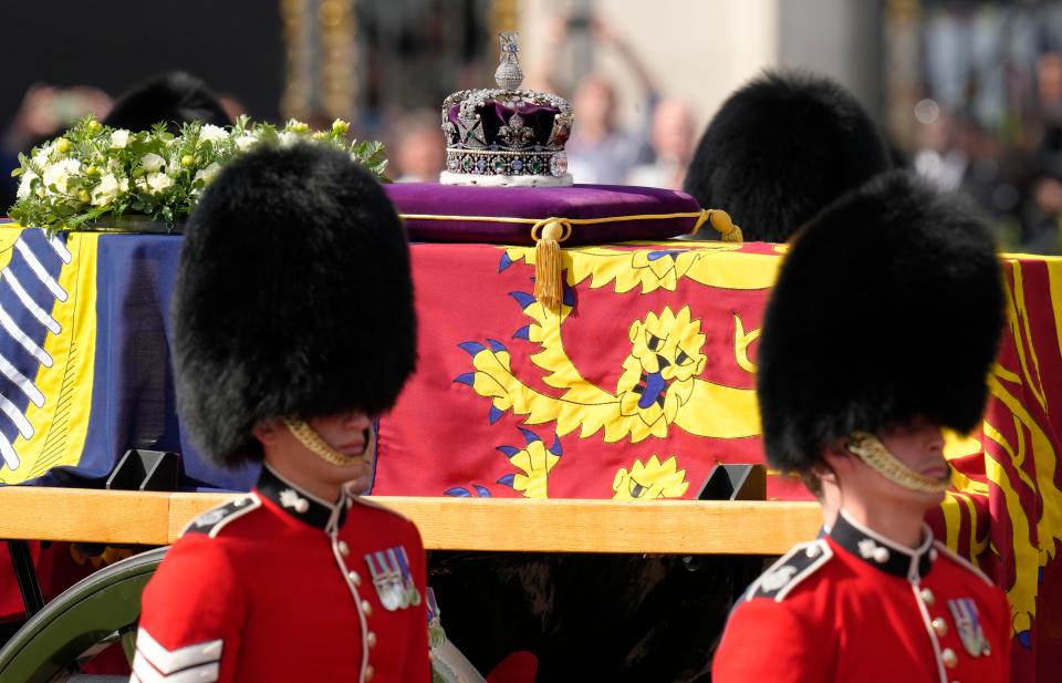 Grenadier Guards flank the coffin of Queen Elizabeth II during a procession from Buckingham Palace to Westminster Hall in London, Wednesday, Sept. 14, 2022.