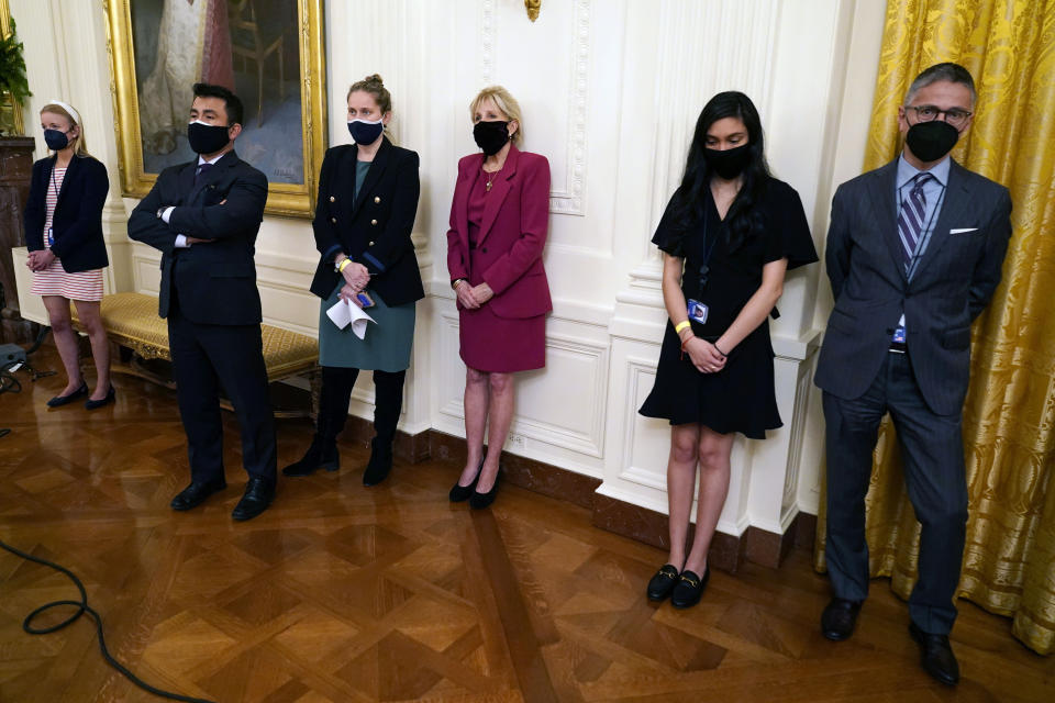 First Lady Jill Biden, center, listens as President Joe Biden speaks about the COVID-19 pandemic during a primetime address from the East Room of the White House, Thursday, March 11, 2021, in Washington. (AP Photo/Andrew Harnik)