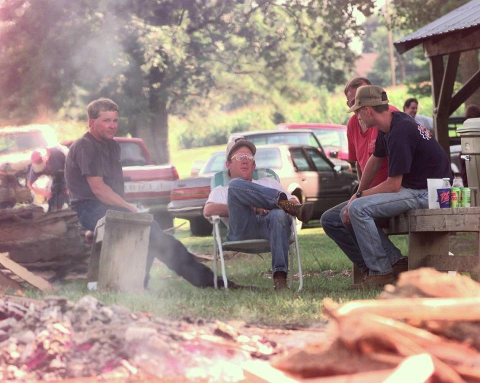 Left to right: Rick Carrico, Gary Hobbs, Eddie Carrico and Steven Allen, 16, watch over the hickory slabs burning down to coals that are put in barbeque pits at the Fancy Farm Picnic grounds in Fancy Farm, KY, Friday, Aug. 1, 1997. They cooked up 18,500 pounds of pork and mutton for the 117th Annual Fancy Farm Political Picnic.