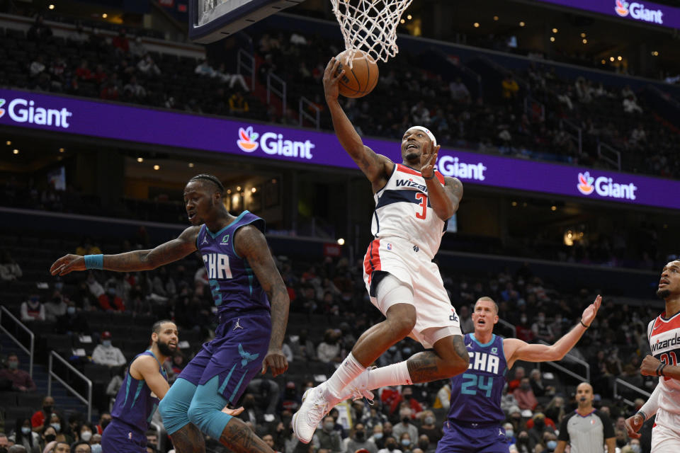FILE - Washington Wizards guard Bradley Beal, center, goes to the basket against Charlotte Hornets guard Terry Rozier, left, and center Mason Plumlee (24) during the first half of an NBA basketball game, Monday, Jan. 3, 2022, in Washington. The NBA's free agency period opens Thursday night, June 30, 2022, with teams and players finally free to negotiate new deals. (AP Photo/Nick Wass, File)