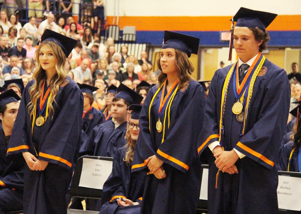 Among the students who graduated with distinction Sunday were Emily Albrecht, left, Ali Barton and Jace Bauknecht.