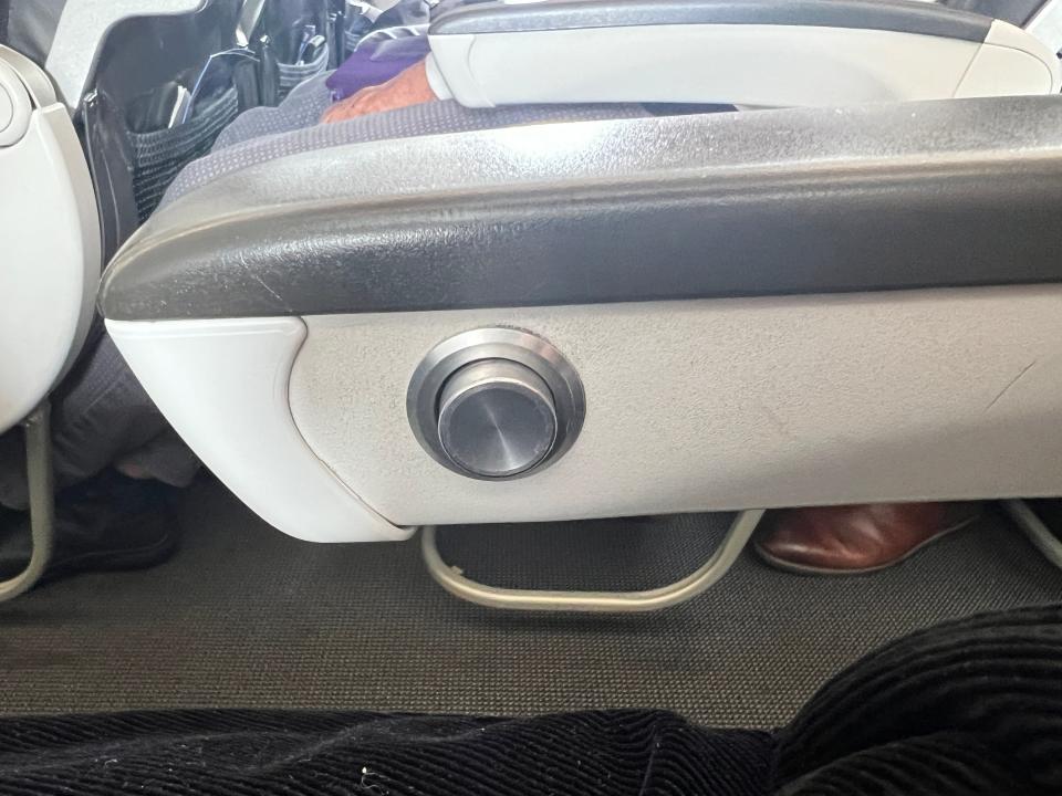 The recline button on an armrest on a British Airways Airbus A320.