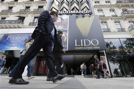 People walk past the Lido cabaret on the Champs-Elysees in Paris June 14, 2013. REUTERS/Gonzalo Fuentes