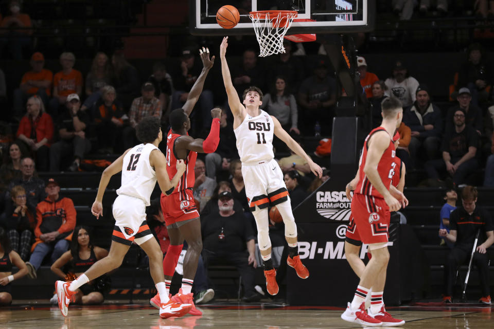 Oregon State forward Dzmitry Ryuny (11) shoots as Utah center Keba Keita, back left, defends during the second half of an NCAA college basketball game in Corvallis, Ore., Thursday, Jan. 26, 2023. Utah won 63-44. (AP Photo/Amanda Loman)