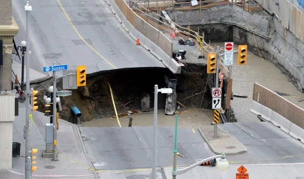 No one was injured by the Rideau Street sinkhole on June 8, 2016, though it did swallow three lanes of the downtown roadway. (Justin Tang/Canadian Press - image credit)