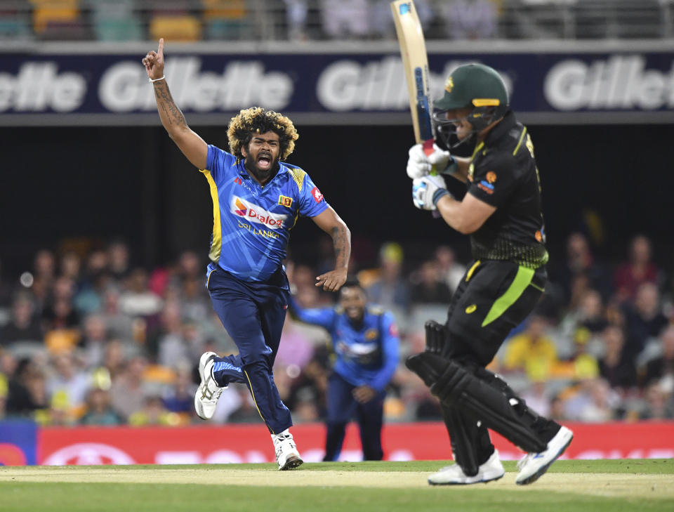 Sri Lanka's Lasith Malinga, left, celebrates the wicket of Australia's Aaron Finch during their T20 cricket match in Brisbane, Wednesday, Oct. 30, 2019. (Darren England/AAP Image via AP)
