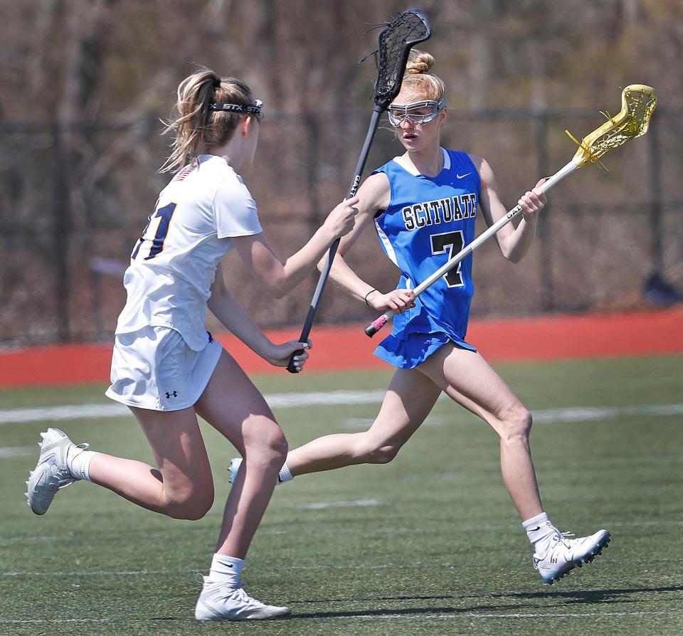 Hanover's Olivia Damon, left, defends against Scituate's Charlotte Spaulding on Friday, April 21, 2023.