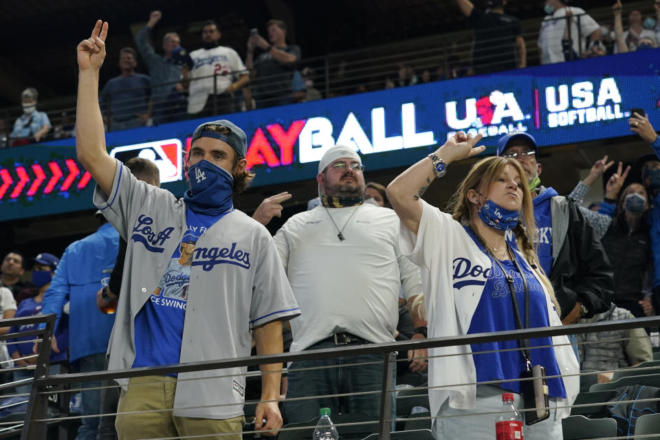 Los Angeles Dodgers fans cheer during the seventh inning in Game 5 of the baseball World Series against the Tampa Bay Rays Sunday, Oct. 25, 2020, in Arlington, Texas. (AP Photo/Eric Gay)